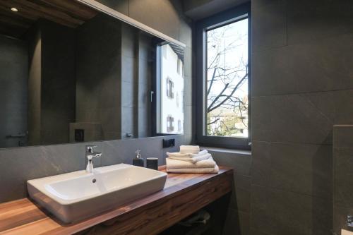 a bathroom with a sink and a mirror at Innerbachlerhof - Mut in Postal