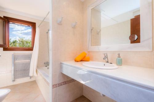 a bathroom with a sink and a mirror at Can Bosco in Son Servera