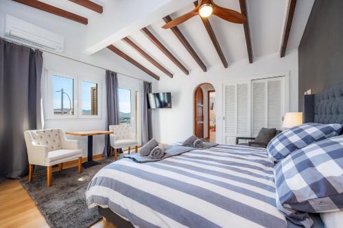 a bedroom with a bed and a table and chairs at Can Eolo in Capdepera