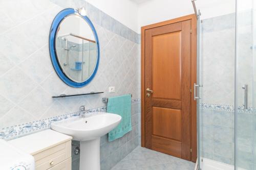 a bathroom with a sink and a mirror at Villa San Teodoro in Nuragheddu