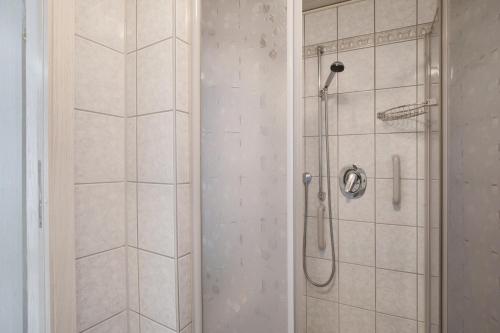 a bathroom with a shower with a glass door at Ferienhaus Doris in Bad Urach