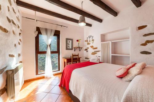 a bedroom with a bed and a large window at Picachico in Laroya