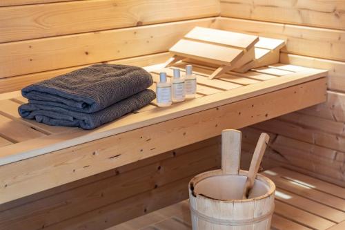 a sauna with a stack of towels on a shelf at Ferienwohnung Silberborth mit Sauna in Seesen