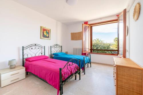 a bedroom with two beds and a window at Stella Vacanze in Otranto