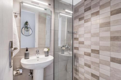 a bathroom with a sink and a shower at Mella Roa - Teal studio in Nydri