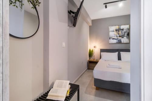 a bedroom with a bed and a mirror and a table at Mella Roa - Teal studio in Nydri