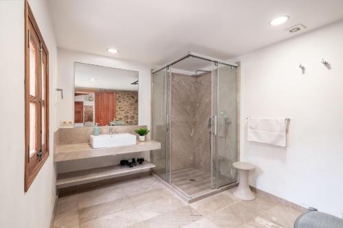 a bathroom with a glass shower and a sink at Villa Agnes in Pollença