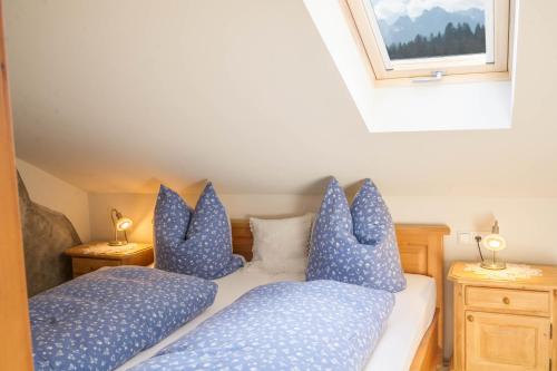 a bedroom with two beds with blue pillows at Ferienwohnung Bergpanorama in Garmisch-Partenkirchen