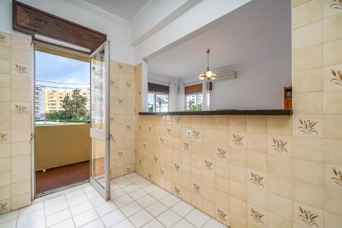 a bathroom with a shower and tiled walls at Squash Club Portimão in Portimão