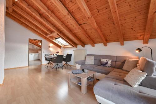 a living room with a couch and a table at Ferienwohnung Alpenvogel in Sonthofen