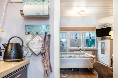 two pictures of a kitchen with a bath room at Ferienwohnung Freesenhuus in Wangerland