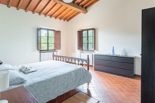 a bedroom with a bed and a kitchen with windows at La Casina di Elisa in Montecarlo