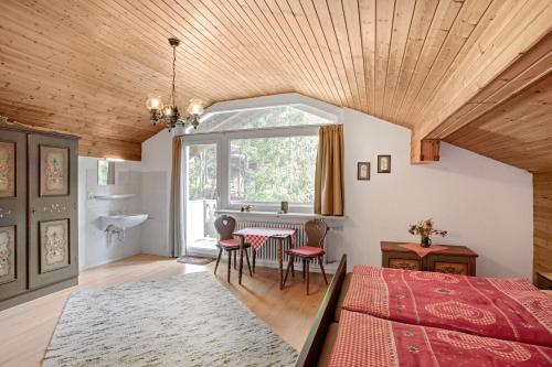 a bedroom with a bed and a table and chairs at Ferienwohnung Haus Reiteralm in Schneizlreuth
