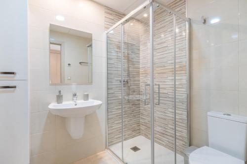 a bathroom with a shower and a sink and a toilet at Terrazas de Campoamor Sunrise in Orihuela