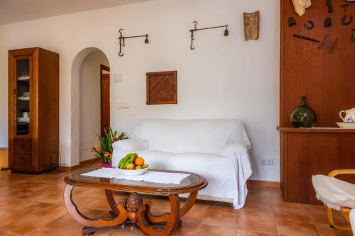 a living room with a white couch and a table at Es Quarteró in Sóller