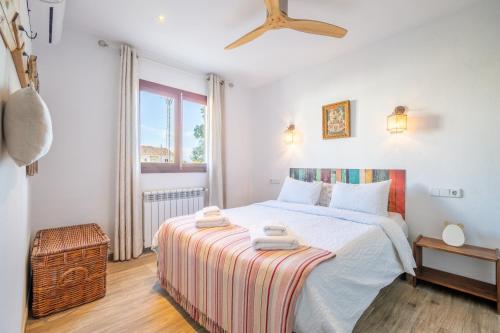 a bedroom with a bed with two towels on it at Casa Cala Santanyí in Santanyi