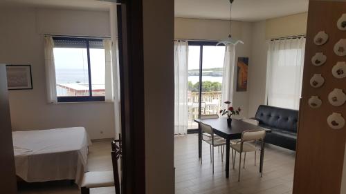 a room with a bed and a table and chairs at Torre dell'orso centralissima vista mare in Torre dell'Orso