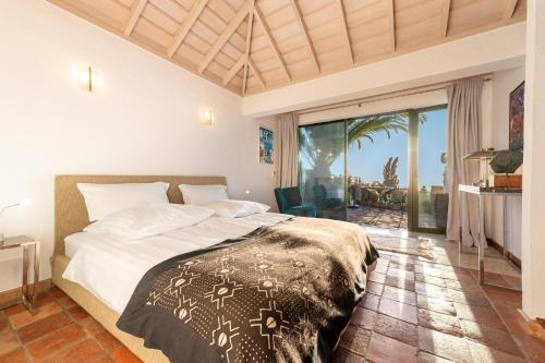 a bedroom with a bed and a large window at Villa Miramar in Puntagorda