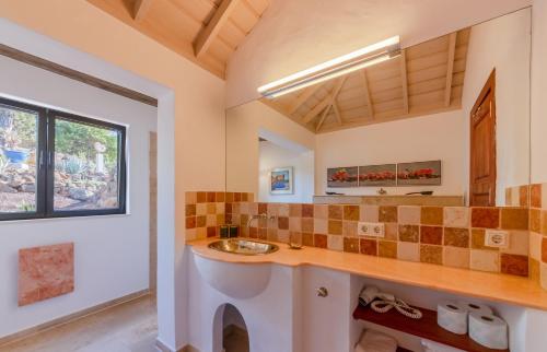 a bathroom with a sink and a window at Villa Miramar in Puntagorda