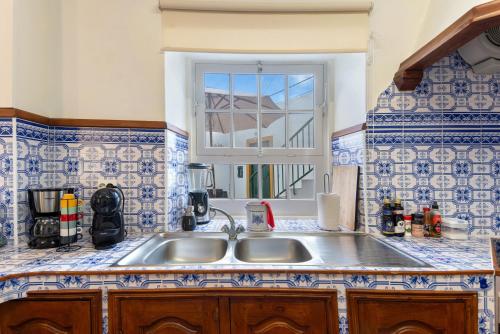 a kitchen with a sink and a window at Casa do Largo - Acores in Ponta Delgada