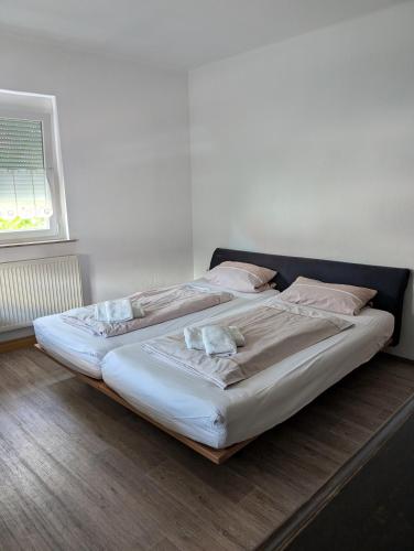 a bedroom with two beds with pillows and a window at Backstubencafe Beck in Ansbach