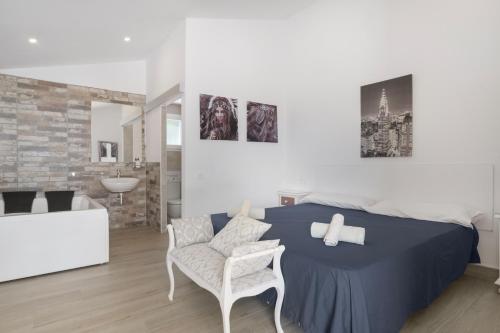 a bedroom with a bed and a chair and a bathroom at Finca El Porvenir in El Gastor