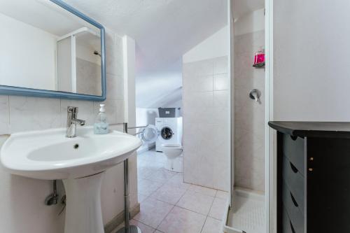 a bathroom with a sink and a toilet at Casa Vacanze Villa Carola in Quartu SantʼElena