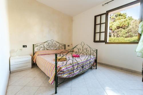 a bedroom with a bed and a window at Casa Vacanze Villa Carola in Quartu SantʼElena