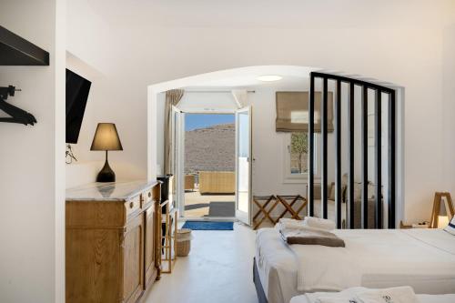 a bedroom with two beds and a view of the desert at Blueros - Grey Suite in Megas Gialos - Nites