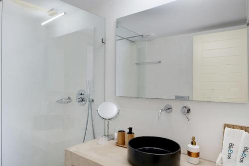 a bathroom with a sink and a mirror at Blueros - Grey Suite in Megas Gialos - Nites