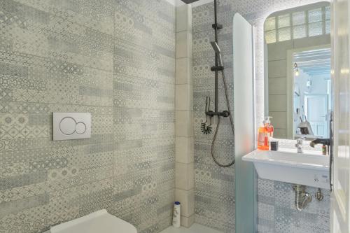 a bathroom with a shower and a sink at Palatino in Astypalaia
