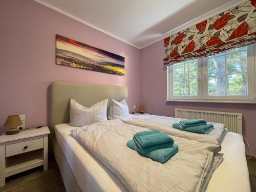 a bedroom with a bed with two pillows on it at Ferienhaus Specht in Zossen