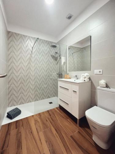a bathroom with a toilet and a sink and a mirror at Jasmine L7 in Armeñime