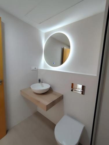 a white bathroom with a sink and a mirror at Paraíso Azul in Nerja