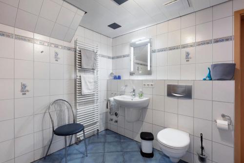 a white bathroom with a toilet and a sink at Ferienwohnung Schweizer in Bernau im Schwarzwald