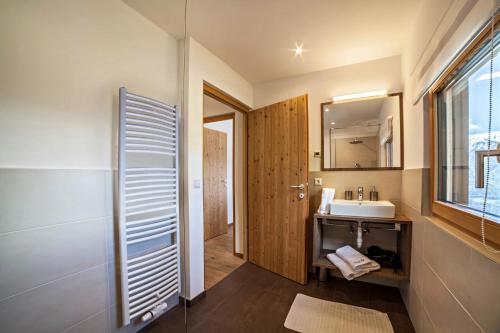 a bathroom with a sink and a mirror at Flatschhof - Chalet Flatsch in Kastelbell-Tschars