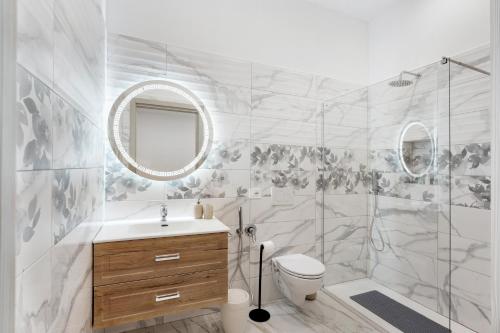 a bathroom with a toilet sink and a shower at Silvana's House in Agerola