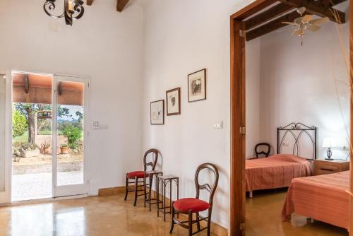 a bedroom with a bed and a table and chairs at Can Espina in Islas Baleares
