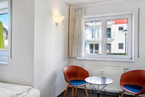 a room with two chairs and a table and a window at Ferienwohnung Tannenblick 6-2 in Oberhof