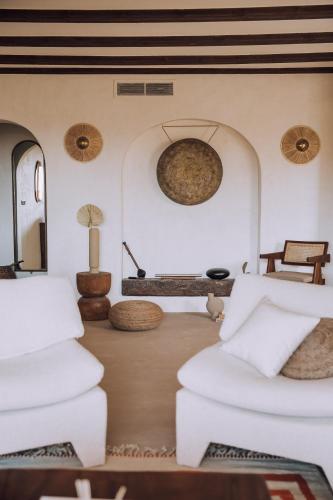 a living room with two white couches and a table at The June Boutique in Benissa