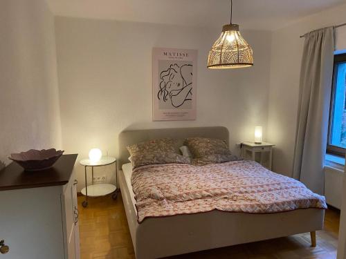 a bedroom with a bed and a pendant light at Ferienwohnung an der Berkelquelle in Billerbeck