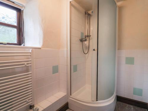 a shower with a glass door in a bathroom at Cider House - near Lyme Regis in Axminster
