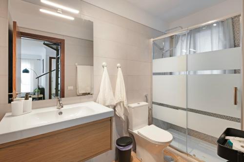 a bathroom with a sink and a toilet and a shower at Atico Olia in Los Llanos de Aridane