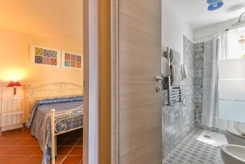 a bathroom with a bed and a sink at Mare e natura in Marciana