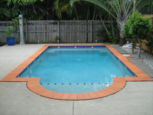 a small swimming pool in a yard with a fence at Clifton Beach House in Clifton Beach