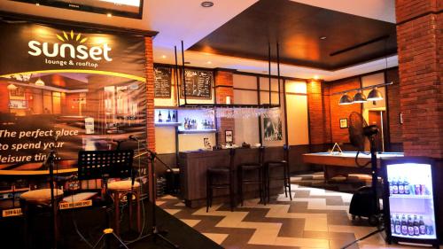 a restaurant with a bar and a pool table at Amarelo Hotel Solo in Solo
