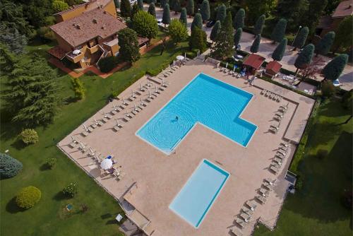 an overhead view of a swimming pool with chairs and a house at APT Garda Lake Sirmione con Piscina - FREE PARKING in Sirmione