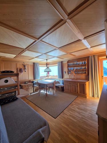 a large living room with a table and a couch at Piciulei Grant in Selva di Val Gardena