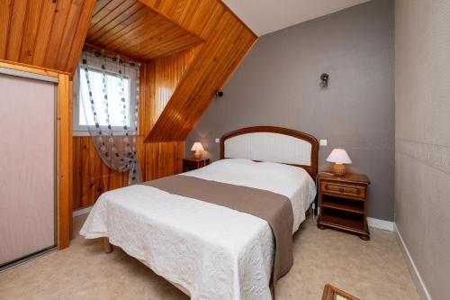 a bedroom with a large bed and a window at Gite Refuge du Blavet 2 étoiles in Saint-Barthélemy