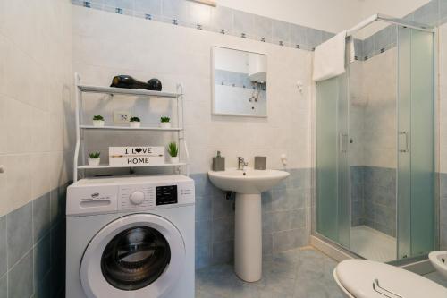 a bathroom with a washing machine and a sink at Kalès home in Otranto in Otranto
